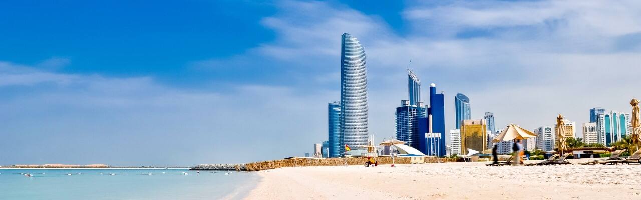 corniche beach with abu dhabi skyline